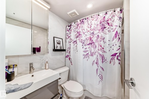 Bathroom with vanity, shower / bathtub combination with curtain, and recessed lighting - 2004 10136 104 Street, Edmonton, AB - Indoor Photo Showing Bathroom