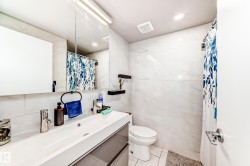 Full bath featuring a shower with curtain, tile walls, vanity, recessed lighting, and light tile patterned flooring - 