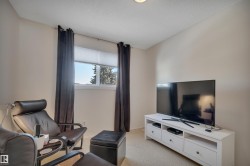 Living room with light colored carpet and a textured ceiling - 