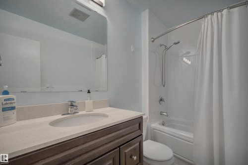 Bathroom featuring vanity and shower / bathtub combination with curtain - 7075 32 Avenue, Edmonton, AB - Indoor Photo Showing Bathroom