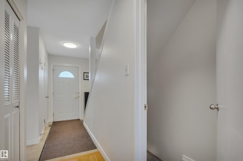 Corridor featuring baseboards and parquet flooring - 7075 32 Avenue, Edmonton, AB - Indoor Photo Showing Other Room