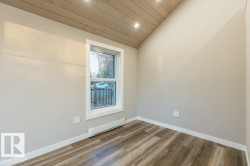 Spare room with a vaulted wood ceiling, baseboard heating, wood finished floors, and recessed lighting - 