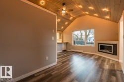 Unfurnished living room featuring ceiling fan, dark wood-style flooring, wooden ceiling, a baseboard heating unit, and recessed lighting - 