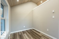 Unfurnished room featuring a vaulted wood ceiling, wood finished floors, a baseboard heating unit, and recessed lighting - 