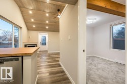 Kitchen with plenty of natural light, stainless steel dishwasher, recessed lighting, ceiling fan, and a vaulted wood ceiling - 