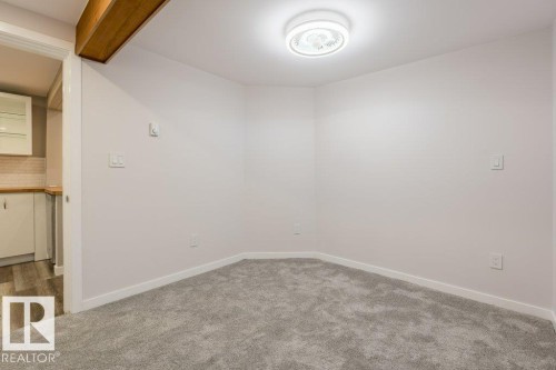 Empty room featuring carpet - 4713 48 Avenue, Wetaskiwin, AB - Indoor Photo Showing Other Room