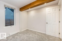 Empty room with light carpet, beamed ceiling, and recessed lighting - 