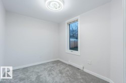 Carpeted spare room featuring baseboards and baseboard heating - 