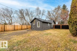View of property exterior featuring a fenced backyard and faux log siding - 