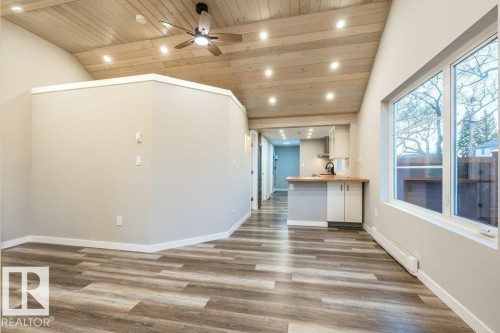 Unfurnished living room with recessed lighting, ceiling fan, a vaulted wood ceiling, dark wood-style flooring, and baseboard heating - 4713 48 Avenue, Wetaskiwin, AB - Indoor Photo Showing Other Room