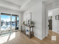 Corridor featuring light wood-style floors and a textured ceiling - 