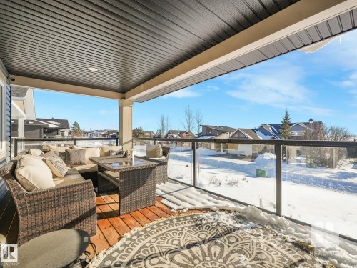 Deck featuring outdoor seating and a residential view - 209 55101 Ste. Anne Trail, Rural Lac Ste. Anne County, AB - Outdoor With Deck Patio Veranda