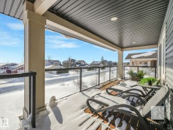 Snow covered back of property with a residential view - 