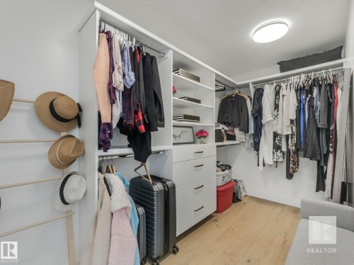 Walk in closet featuring light wood finished floors - 209 55101 Ste. Anne Trail, Rural Lac Ste. Anne County, AB - Indoor With Storage