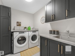 Laundry room featuring washer and clothes dryer and cabinet space - 