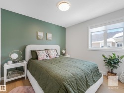 Bedroom with wood finished floors and baseboards - 