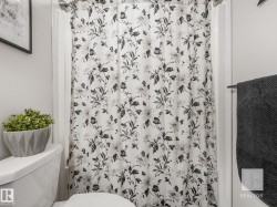 Bathroom featuring toilet and a shower with shower curtain - 