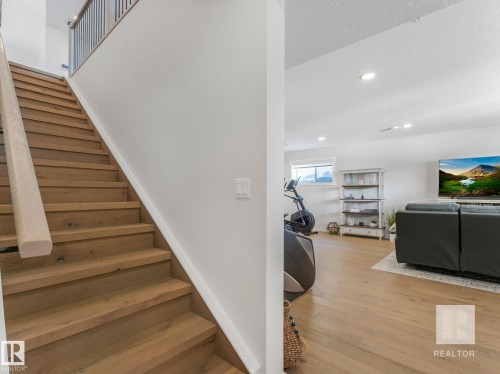 Stairs with wood finished floors, a textured ceiling, and recessed lighting - 209 55101 Ste. Anne Trail, Rural Lac Ste. Anne County, AB - Indoor Photo Showing Other Room