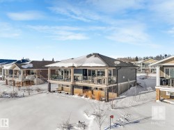 Snow covered rear of property with a deck - 