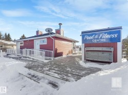 Snow covered property featuring a deck and a chimney - 