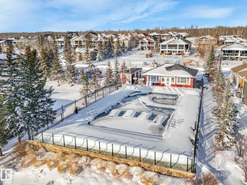Snowy aerial view with a residential view - 209 55101 Ste. Anne Trail, Rural Lac Ste. Anne County, AB - Outdoor With View
