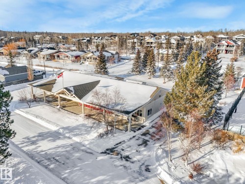 Snowy aerial view with a residential view - 209 55101 Ste. Anne Trail, Rural Lac Ste. Anne County, AB - Outdoor With View