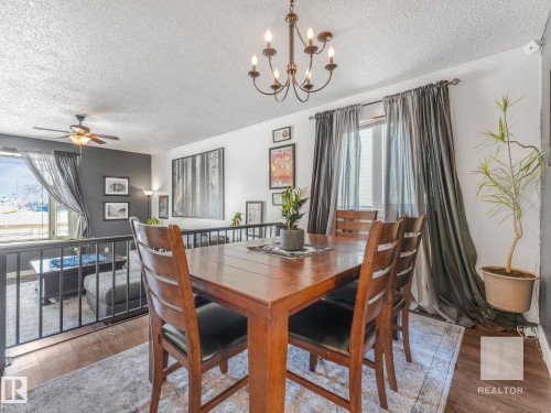 Dining room featuring wood finished floors, suspended lighting, a textured ceiling, and a ceiling fan - 4504 48 Avenue, Onoway, AB - Indoor Photo Showing Dining Room