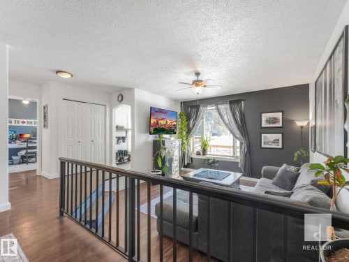 Living room featuring ceiling fan, wood finished floors, and a textured ceiling - 4504 48 Avenue, Onoway, AB - Indoor Photo Showing Other Room