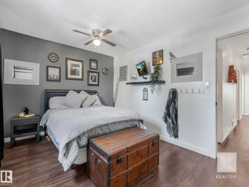 Bedroom featuring dark wood finished floors, a textured ceiling, and ceiling fan - 4504 48 Avenue, Onoway, AB - Indoor Photo Showing Bedroom