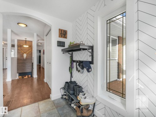 Hall with arched walkways and baseboards - 4504 48 Avenue, Onoway, AB - Indoor Photo Showing Other Room