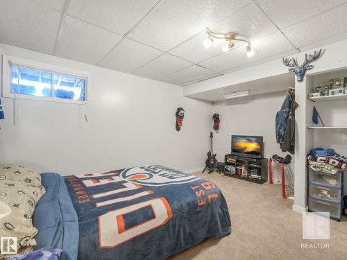 Bedroom featuring a paneled ceiling and light colored carpet - 4504 48 Avenue, Onoway, AB - Indoor Photo Showing Bedroom