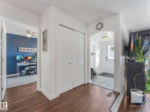 Foyer featuring a textured ceiling, dark wood finished floors, and arched walkways - 4504 48 Avenue, Onoway, AB - Indoor Photo Showing Other Room