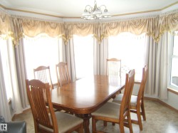 Dining area featuring a chandelier, plenty of natural light, and crown molding - 