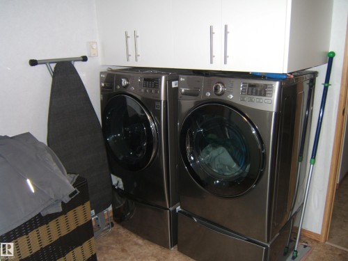 Laundry area featuring washer and dryer and cabinet space - 125076 Twp Rd 540, Rural Two Hills County, AB - Indoor Photo Showing Laundry Room