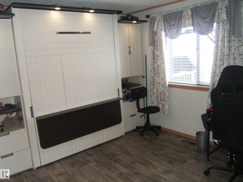 Misc room with dark wood-style flooring and crown molding - 125076 Twp Rd 540, Rural Two Hills County, AB - Indoor Photo Showing Other Room