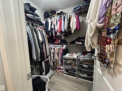 Walk in closet featuring light wood-style floors - 