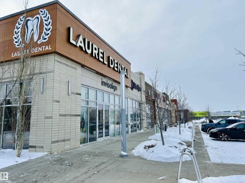 Snow covered building featuring view of commercial area - 120 1530 Tamarack Boulevard, Edmonton, AB - Outdoor