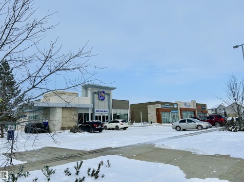 Snow covered building with view of commercial area and uncovered parking - 120 1530 Tamarack Boulevard, Edmonton, AB - Outdoor