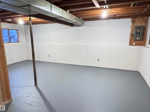 Unfinished basement featuring electric panel - 4919 49 Avenue, Vimy, AB - Indoor Photo Showing Basement