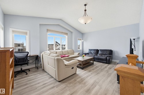 Living area featuring a desk, vaulted ceiling, and light wood-type flooring - 4020 157A Avenue, Edmonton, AB - Indoor Photo Showing Living Room