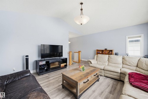 Living area featuring light wood-style flooring and lofted ceiling - 4020 157A Avenue, Edmonton, AB - Indoor Photo Showing Living Room