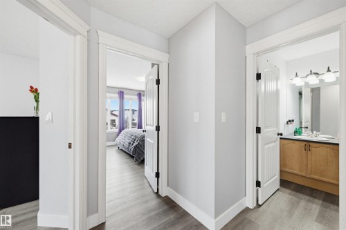 Corridor with light wood-style floors and a textured ceiling - 4020 157A Avenue, Edmonton, AB - Indoor Photo Showing Other Room