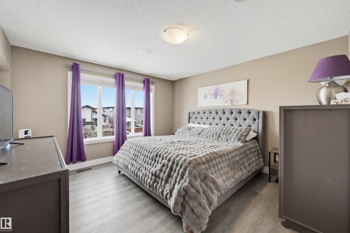 Bedroom with light wood finished floors and a textured ceiling - 4020 157A Avenue, Edmonton, AB - Indoor Photo Showing Bedroom