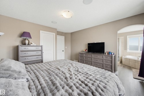 Bedroom featuring wood finished floors and arched walkways - 4020 157A Avenue, Edmonton, AB - Indoor Photo Showing Bedroom
