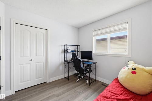 Home office featuring wood finished floors and a textured ceiling - 4020 157A Avenue, Edmonton, AB - Indoor Photo Showing Bedroom