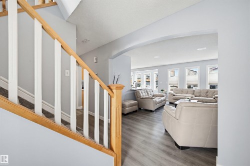 Living room with arched walkways and wood finished floors - 4020 157A Avenue, Edmonton, AB - Indoor
