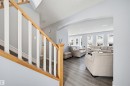 Living room with arched walkways and wood finished floors - 4020 157A Avenue, Edmonton, AB  - Indoor 