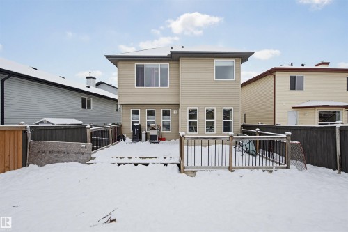 Snow covered property featuring a fenced backyard and a deck - 4020 157A Avenue, Edmonton, AB - Outdoor With Deck Patio Veranda With Exterior