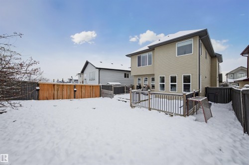 Snow covered property featuring a fenced backyard and a deck - 4020 157A Avenue, Edmonton, AB - Outdoor With Deck Patio Veranda With Exterior