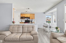 Living room featuring light wood-type flooring and a textured ceiling - 